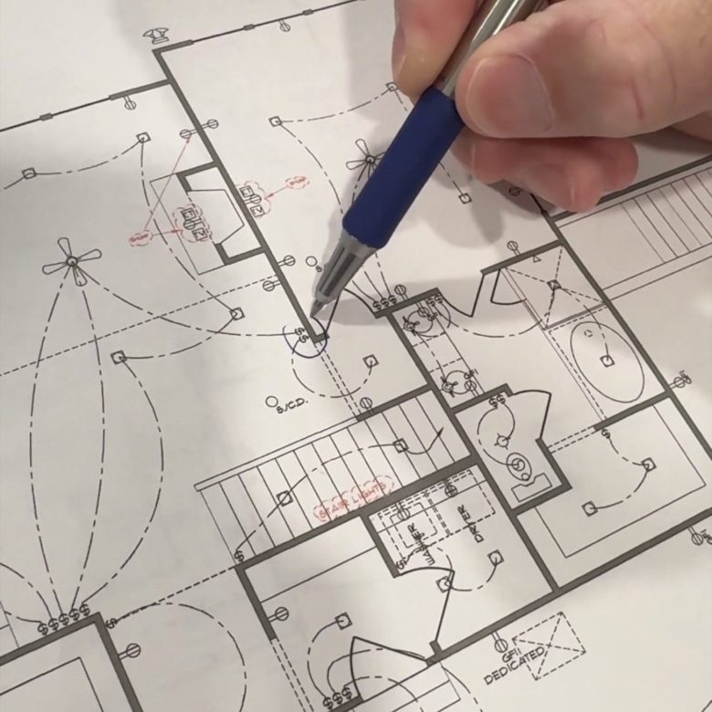 Hands holding pen adjusting custom floorplans